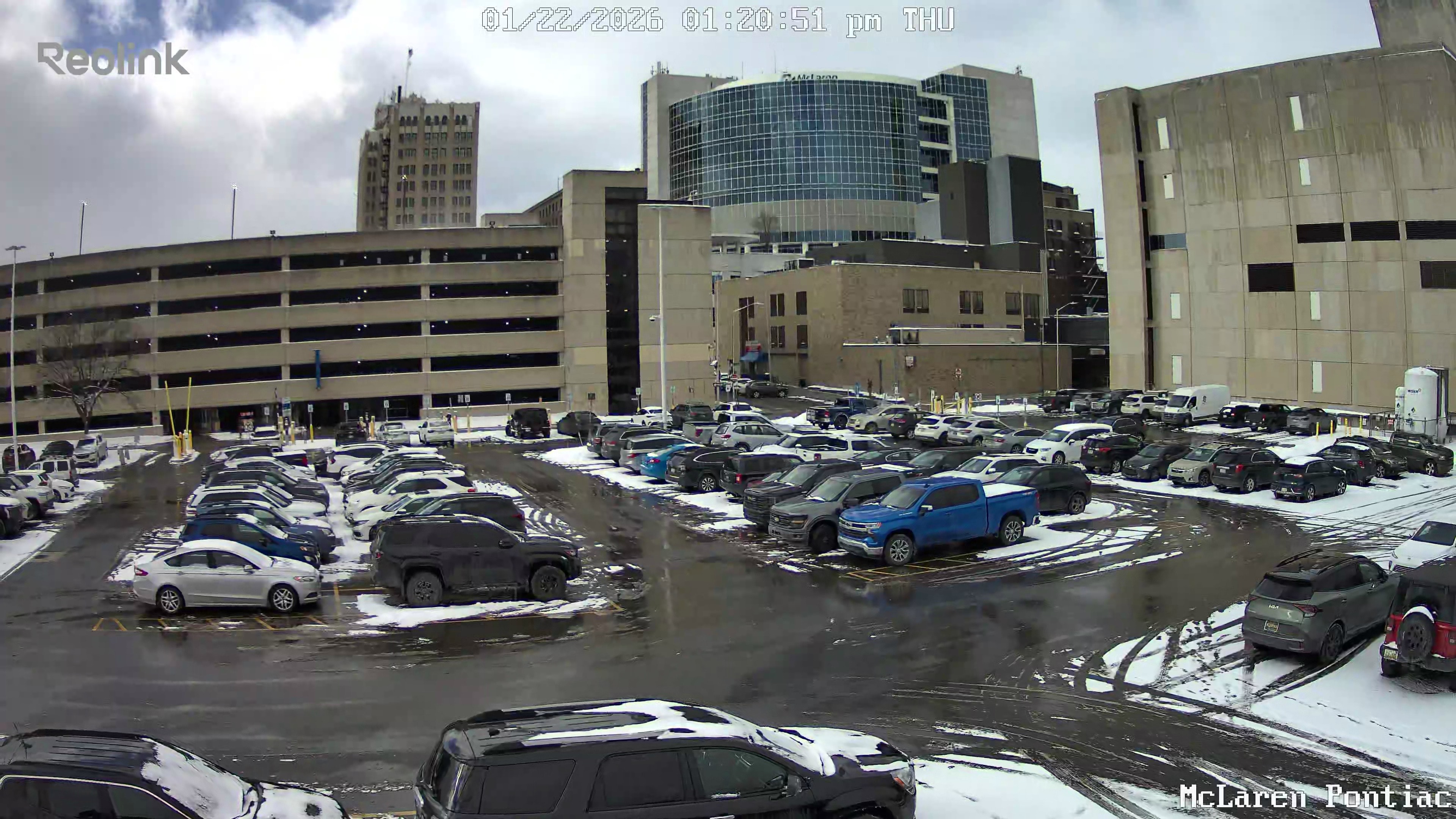 Aerial view of an ice-treated commercial parking lot in Oakland County, MI
