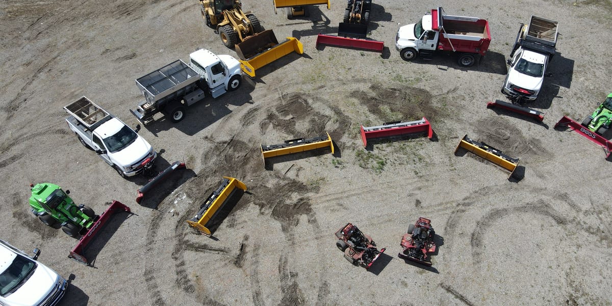Commercial snow plowing trucks and snow removal equipment arranged in a fleet
