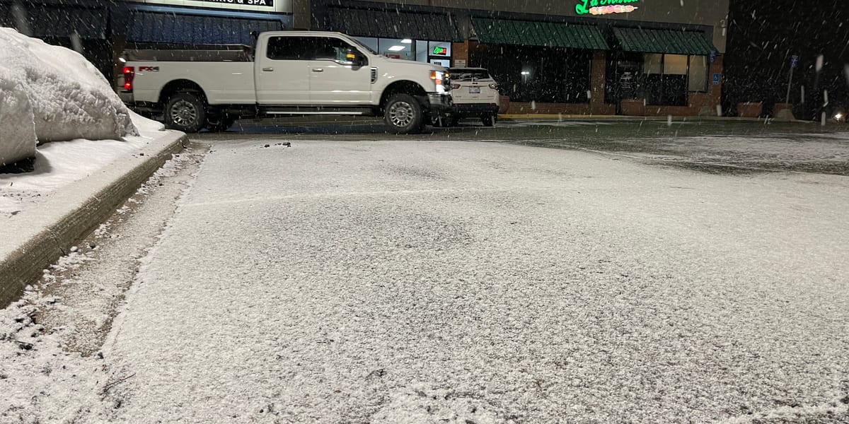 Snow-covered commercial parking lot outside a business prepared for snow removal