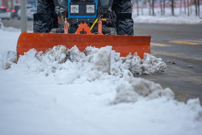 Commercial snow removal service using a snow plow in Troy, MI
